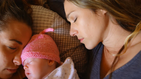 lesbian couple sleeping with their baby boy at home 4k