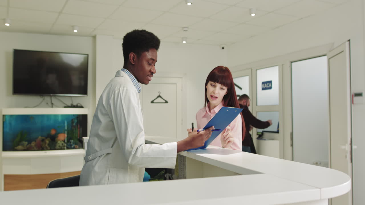 A young african american doctor takes a patient to the hospital registration of documentation before