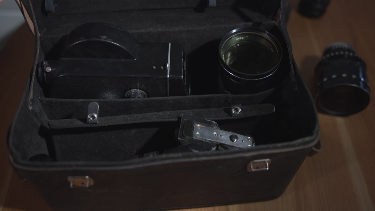 Open Leather Case Revealing Lenses And Camera Parts, Foam Compartments And Glass Elements, Organized Storage . Media