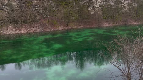 Stagnant-Canyon-River-With-Green-Moss-In-A-National-Park-Forest-In-Germany-On-A-Dramatic-Day