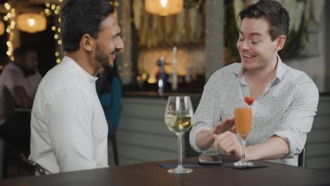 tracking shot approaching two men talking during date