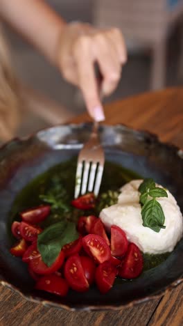 woman eating caprese salad