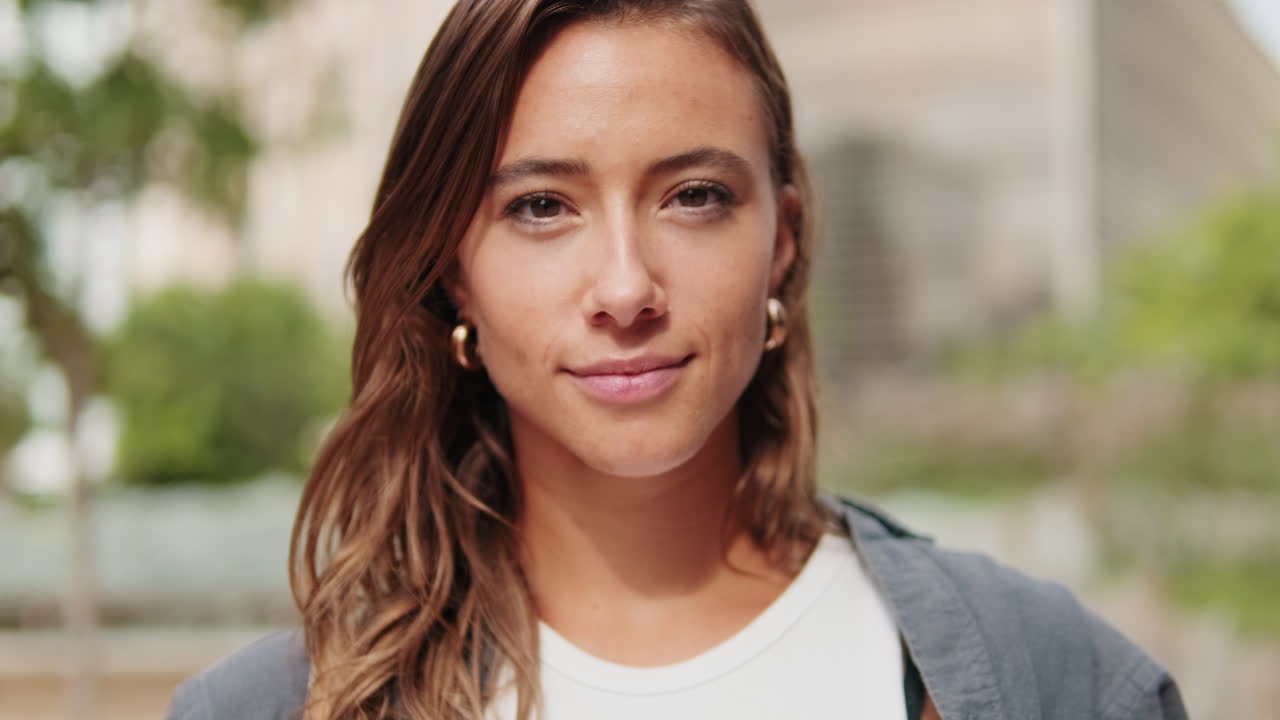 Close-up of European young woman, pretty female studet smiling outdoors with