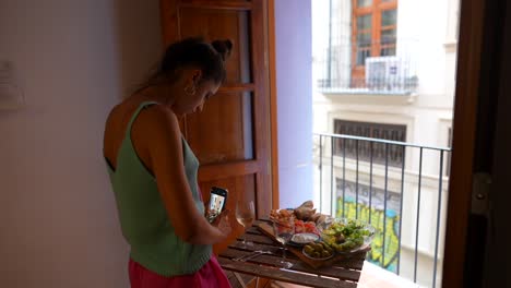 woman enjoying a meal with a city view