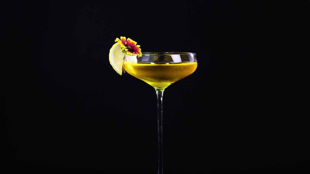 Elegant Yellow Cocktail with Flower Garnish