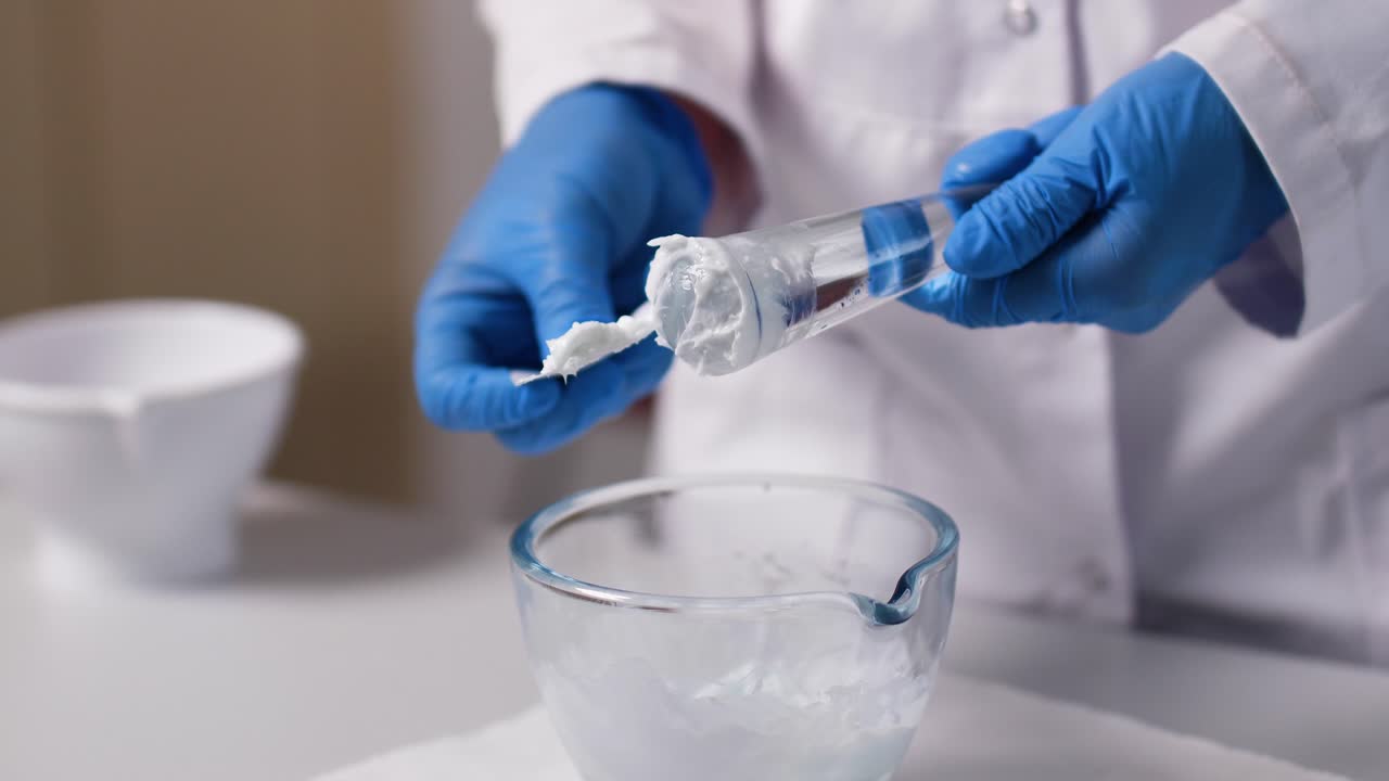 Premium stock video - A cream is mixed by an pharmaceutical assistant