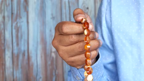 hand holding prayer beads