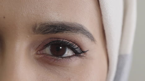 young muslim woman eye opening looking at camera blinking wearing hijab feminine beauty close up