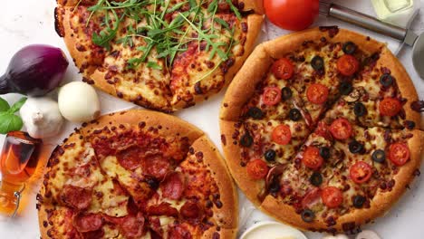 Three-american-style-pizzas-served-on-a-table