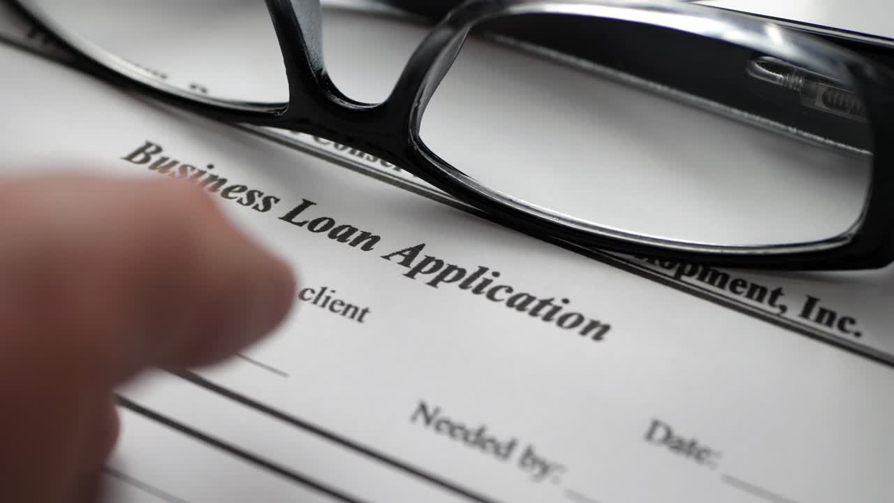 Finger tapping on business loan application
