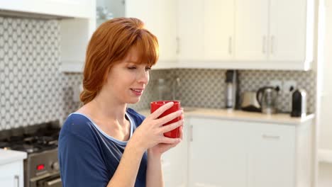 Beautiful-woman-having-coffee-in-kitchen-4k