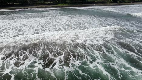 Lone-surfer-waiting-to-catch-a-wave