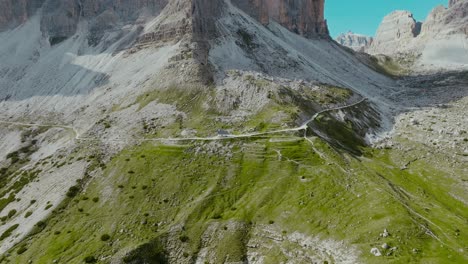 aerial drone shot of a house in the tre cime di lavaredo in the dolomites alps in italy, 4k