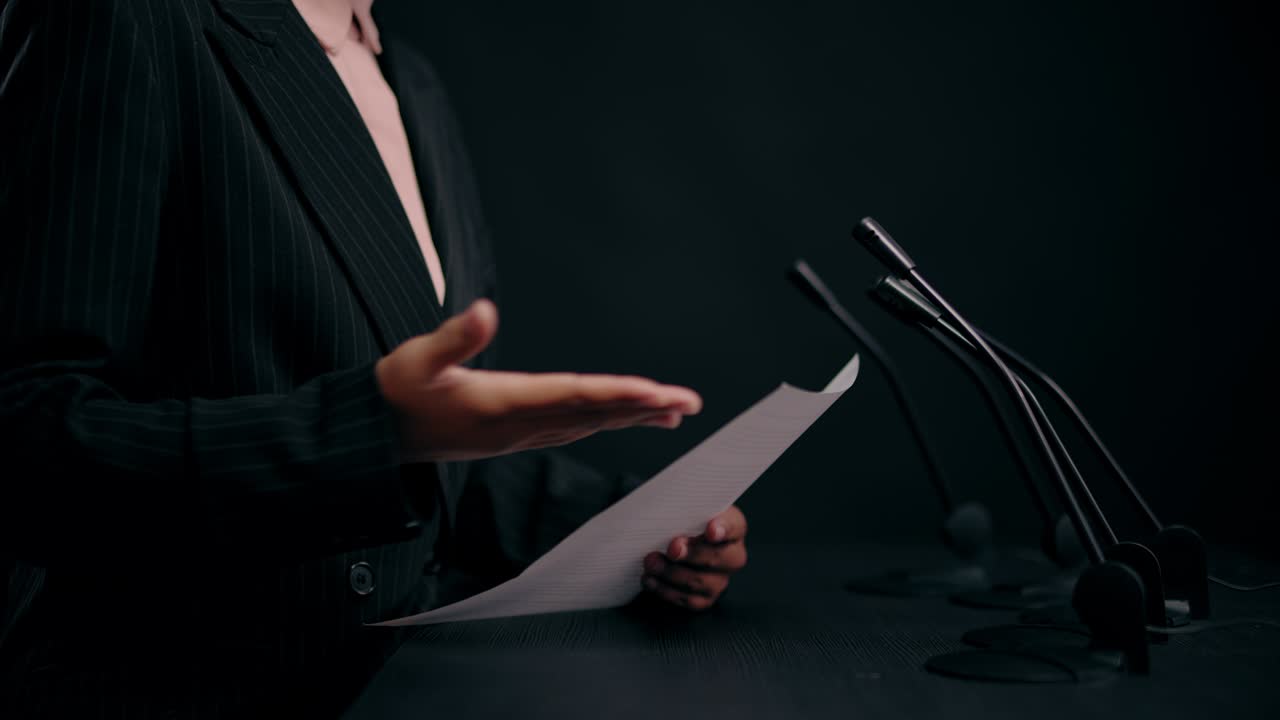 Hands of female teacher holding paper, reading lecture to students, education
