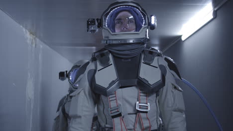 astronauts in a spaceship corridor
