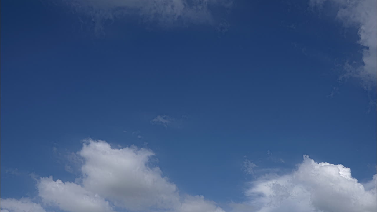 This timelapse captures dynamic movement of clouds in a serene open sky