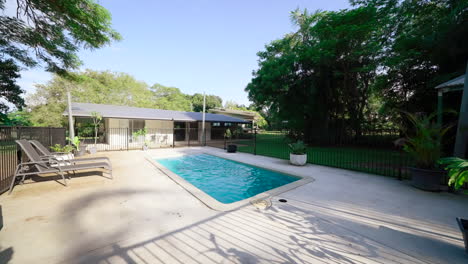 large tropical backyard pool seating area on gated rural property