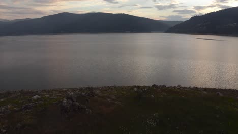 Stunning-drone-shot-of-a-calm-lake-during-a-beautiful-sunset-in-Macedonia