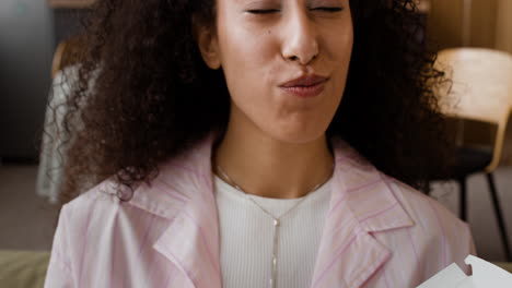 woman enjoying eating fried chicken