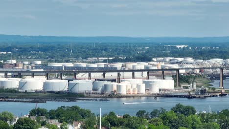 Aerial-wide-shot-showing-traffic-on-bridge-over-industrial-Kinder-Morgan-Inc-Terminal-in-New-Jersey,-USA