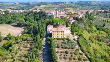 road beautiful aerial top view flight tuscany medieval village mediterranean wine growing region drone camera pointing down