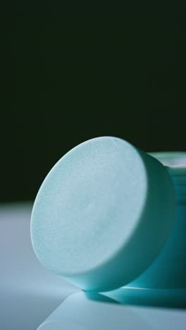 light teal cosmetic jar or container