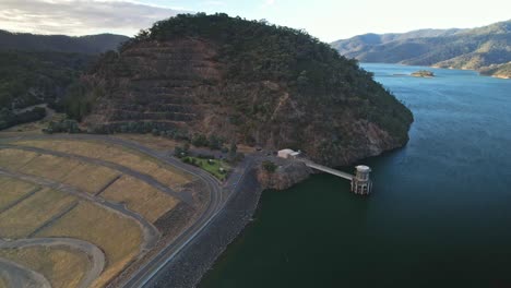 sobre la pared de la presa y hacia la torre de admisión en el lago eildon, victoria, australia