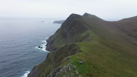 cinematic wide aerial drone shot of the mountain coastal edge at keem beach, ireland