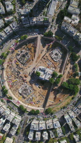 vertical video drop down rotation over kikar (square ) hamedina impressive project construction - tel aviv, israel