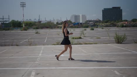 woman walking in an empty parking lot