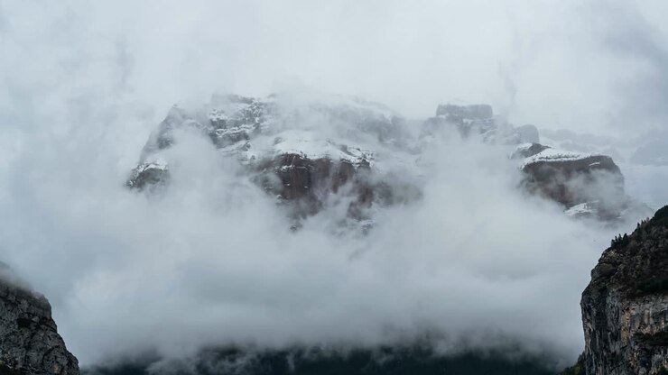 Time lapse of some clouds over snowy mountains