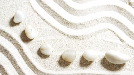 Various-pebble-stone-arranged-on-sand