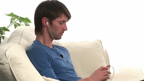 Attractive-Man-on-Sofa-Listening-to-Music