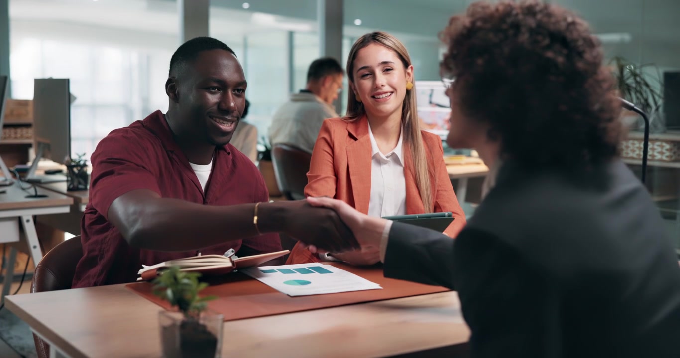 Business Professionals Shaking Hands During a Meeting in a Modern Office