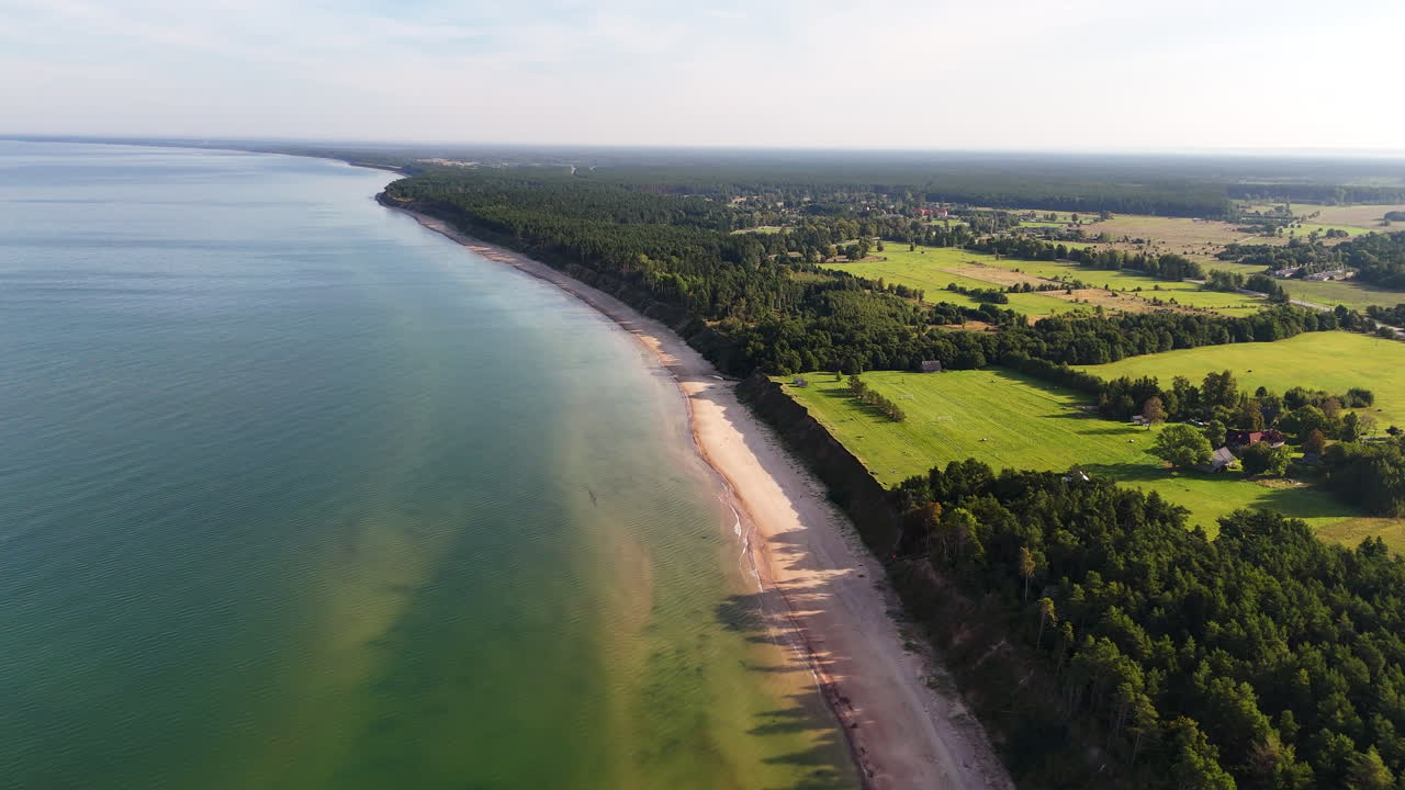 Steep coastal cliffs and green countryside meet the Baltic Sea in Jurkalne, Latvia.