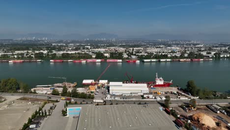 long queue of intermodal containers on fraser river at daytime in delta, bc, canada