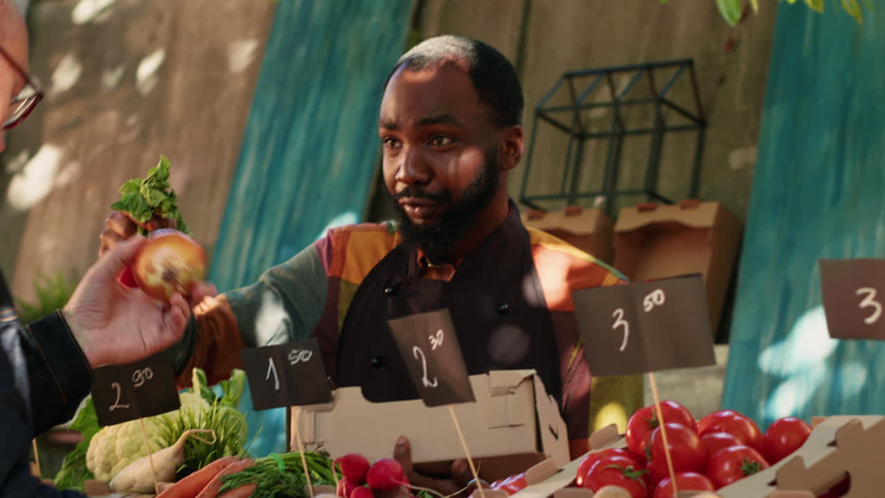 People buying fruits and vegetables at local market