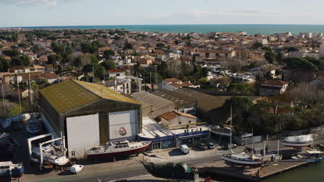 ship repair yard aerial drone shot sunny day discovering grau d'agde city