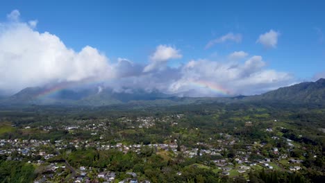 Cinematic-arial-view-with-rainbow-in-cloudy-sky-in-Kauai,-Hawaii