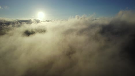 Flying-through-the-clouds,-sun-as-background