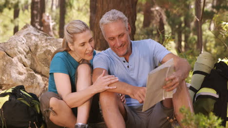 Couple-using-map-and-compass-to-find-the-way