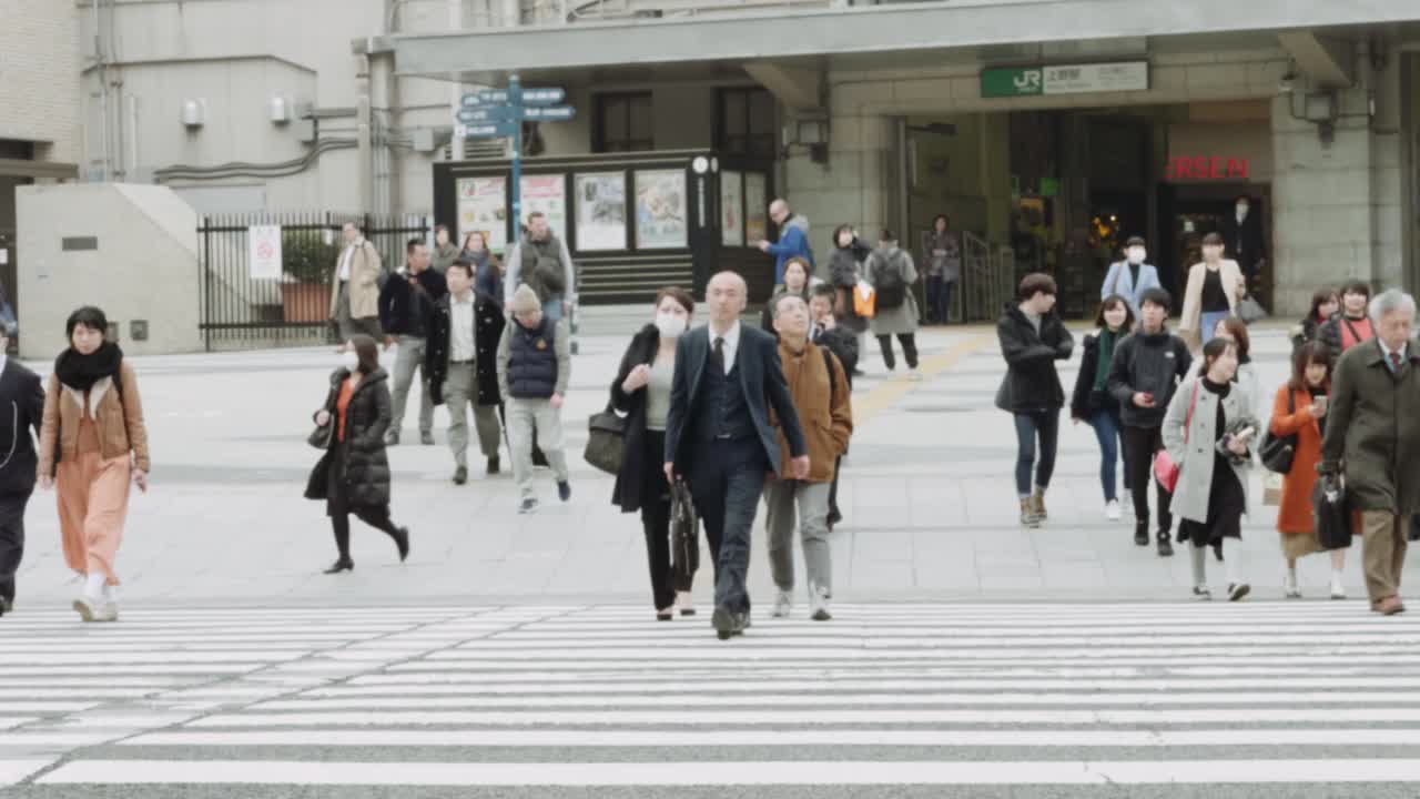 Tokyo Citizens cross the road at Ueno Station in Slow Motion