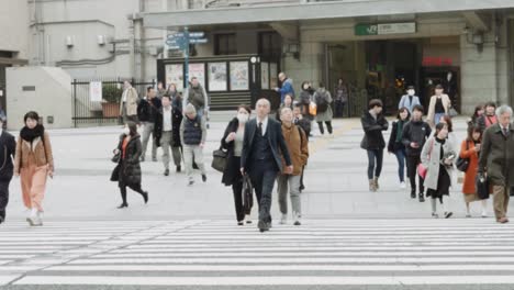 tokyo citizens cross the road at ueno station in slow motion
