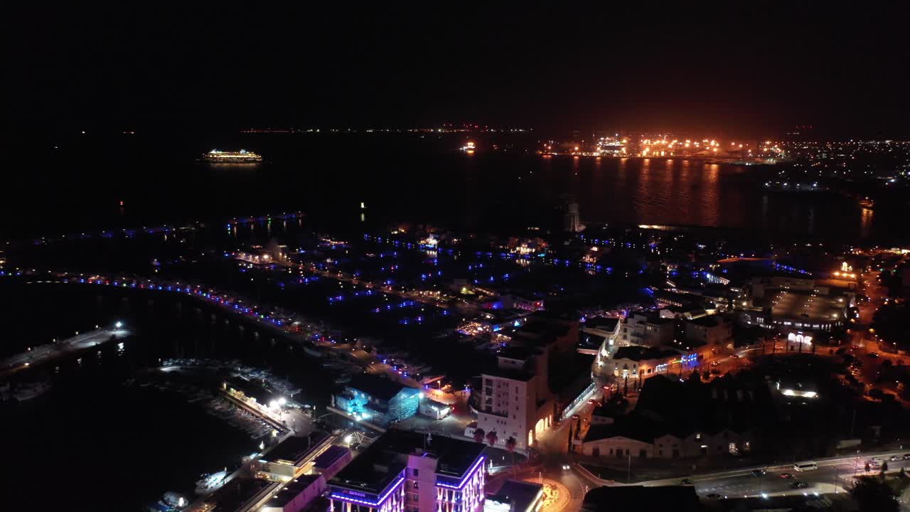 Illuminated night view of Limassol marina.