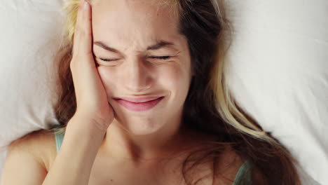 attractive-young-woman-waking-up-in-bed