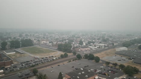 aerial drone view of town covered in smog