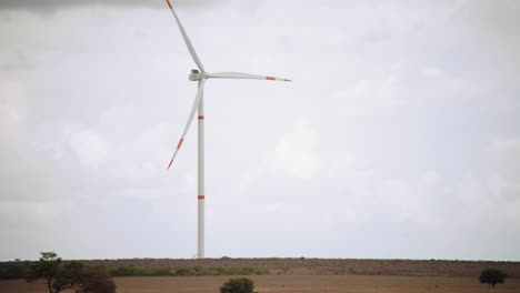 Clouds,-the-horizon,-and-a-wind-turbine-in-a-wind-energy-farm,-Mexico,-wide-shot