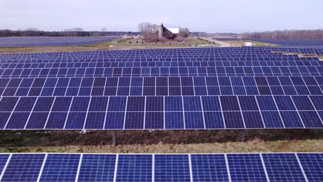 Low-sideways-aerial-of-solar-panel-rows-at-power-station-in-Michigan