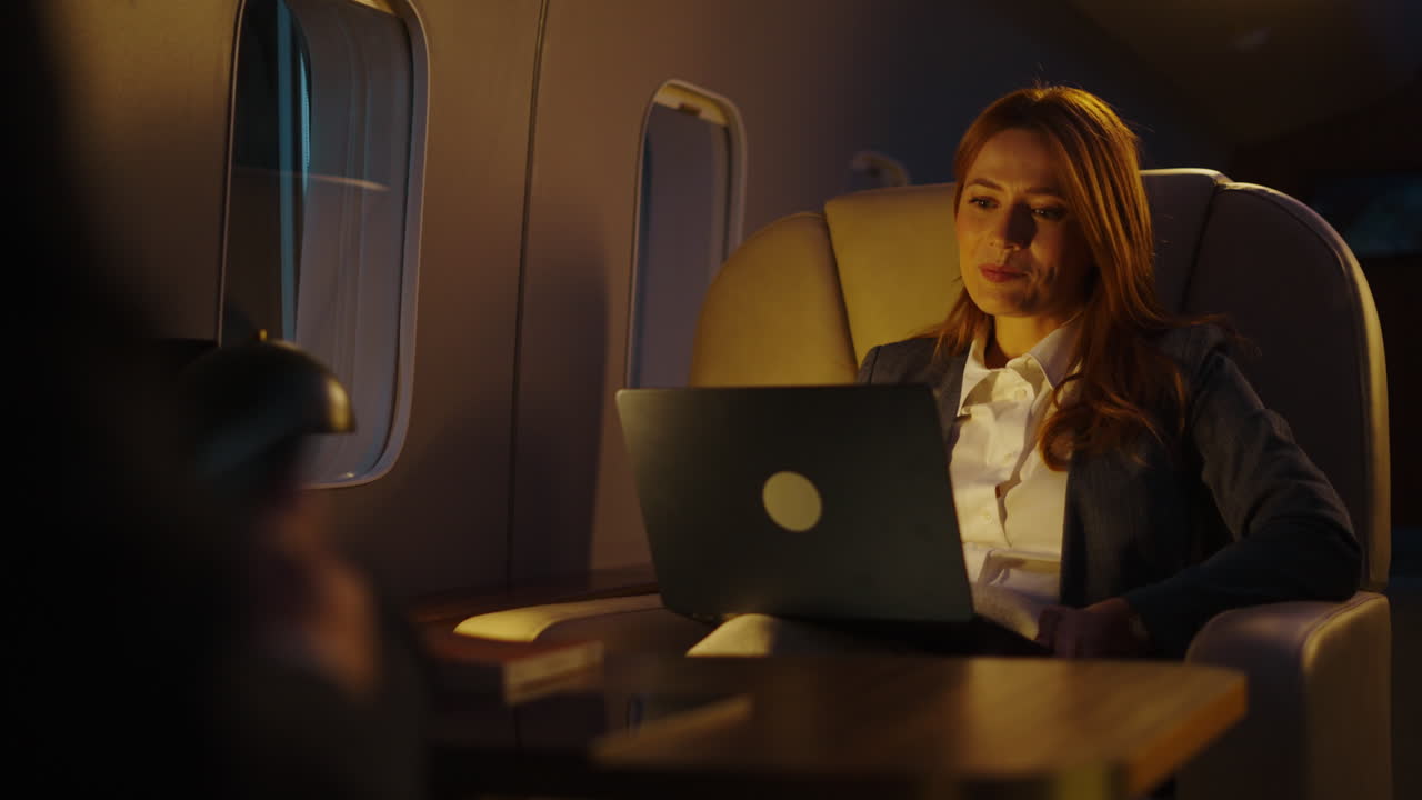 Businesswoman working on laptop during private jet flight