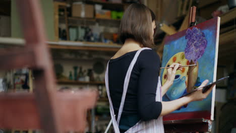 woman painting still life in art studio